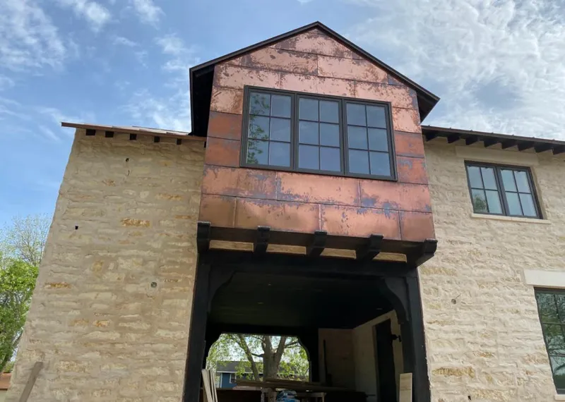 Copper metal panel facade on a stone building for Roof Repair in Closter