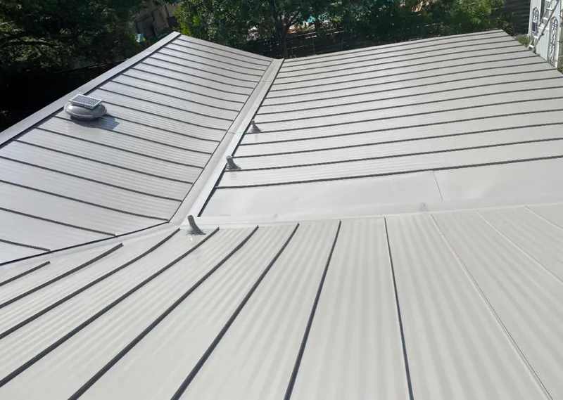 Solar attic fan installed on a metal roof for Roof Ventilation in Closter